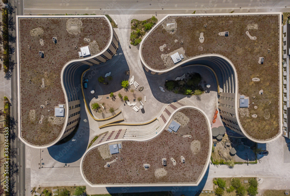 Aerial view of university buildings. Overhead shot of building roofs in park environment.