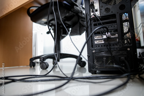 Concept of clutter in office. Unwound and tangled electrical wires under the table. 5S system of lean manufacturing