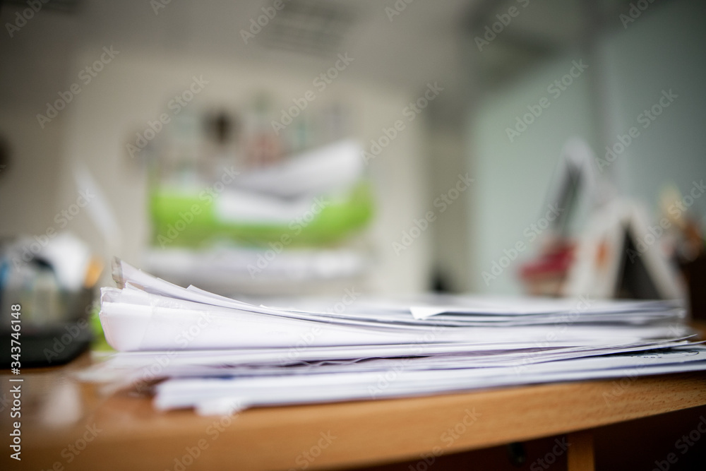 Pile of documents on desk stack up high waiting to be managed. Pile of documents on desk stack up high waiting to be managed.