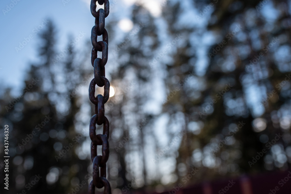 A rusty chain amid the sun and sky.