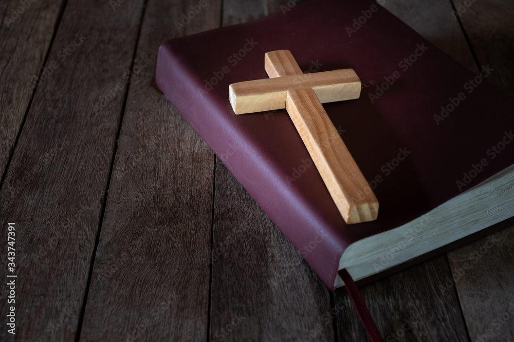 The crucifix lay on the bible. It is a blessing from God with the power and power of holiness, which brings luck and shows forgiveness with the power of religion, faith, worship, Christian thought.