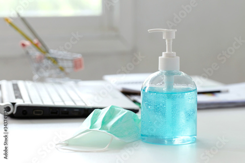 Wallpaper Mural Working from home.Coronavirus prevention medical surgical masks and hand sanitizer gel put on the desk. Torontodigital.ca