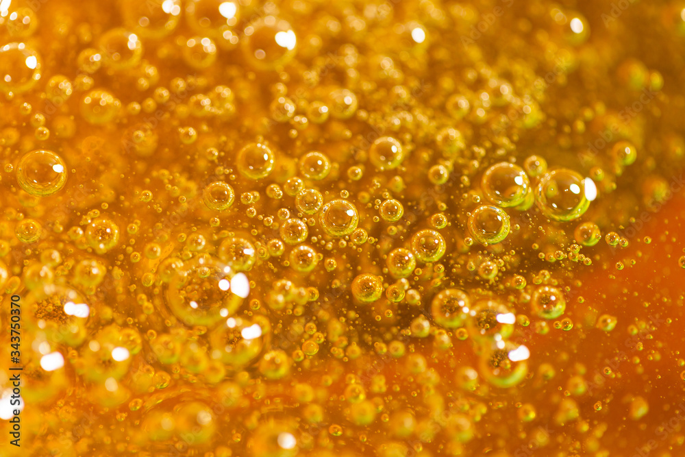 Detail of abstract orange bubble, can be used for background. Paste for sugaring close-up. Depilation and hair removal concept. Macro photo. Detail of abstract orange bubble, can be used for background. Paste for sugaring close-up. Depilation and hair removal concept. Macro photo.