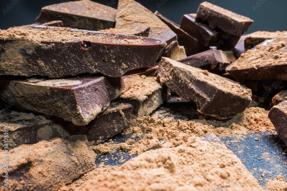 Chopped chocolate with cocoa, big pieces. Dessert, sugar, carbohydrates and fats concept. Chopped chocolate with cocoa, big pieces. Dessert, sugar, carbohydrates and fats concept.