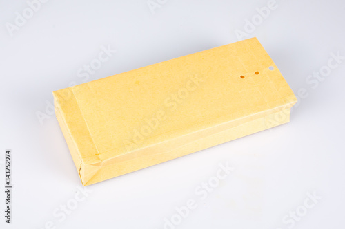 Kraft brown paper square perforated closure envelope on white background