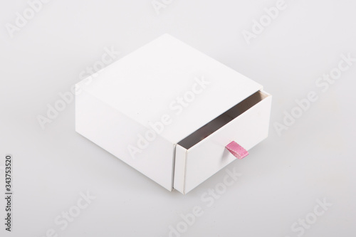 Opened cardboard sliding box with drawer pink ribbon