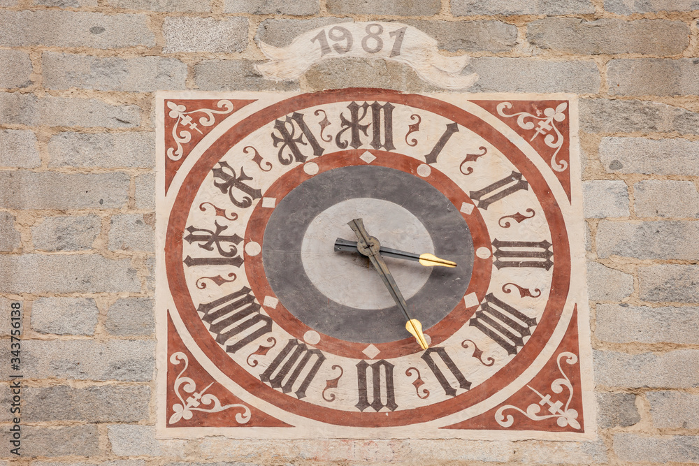 The clock painted and recently restored outside the bell tower of the church in Tiso..