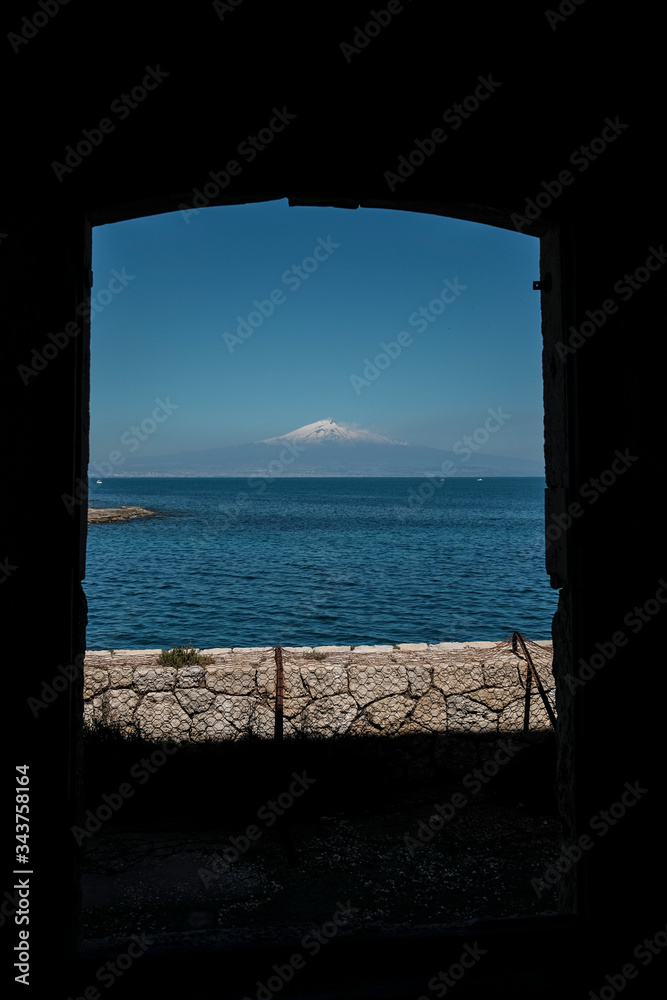 A view of Mount Etna from a window.