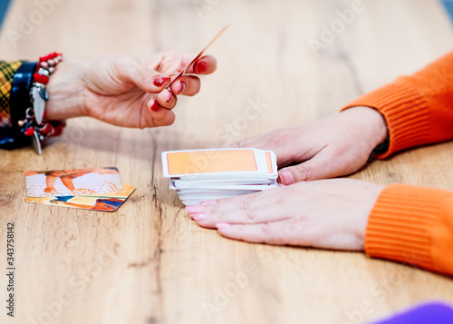 Фотография The psychologist works with metaphorical cards with the client at the desk