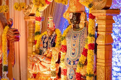 The idol of Lord Balaji and Lakshmi decorated with ornaments and flowers at a South-Indian Hindu wedding