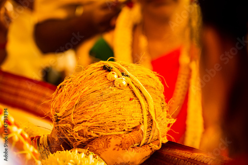 Close up of mangalsutra on a coconut at a South-Indian Hindu wedding