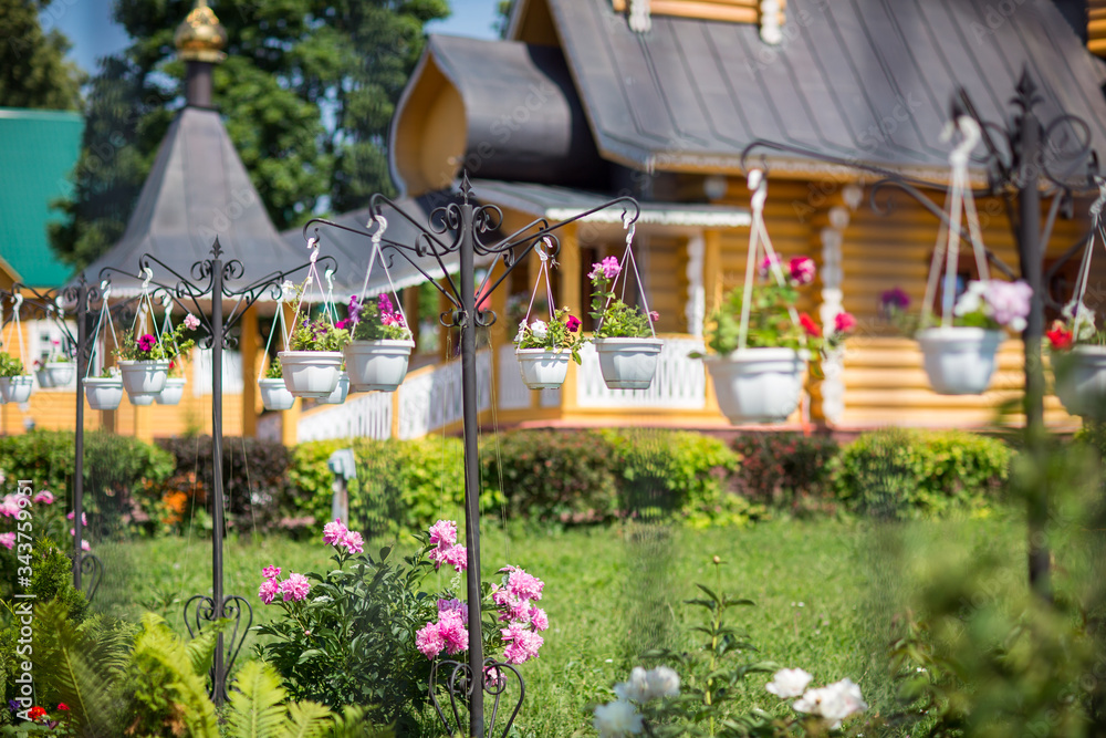 outdoor decoration of christian wooden church with beautiful garden and flowers