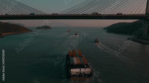 Container/cargo ships entering Hong Kong Harbour at sunset 