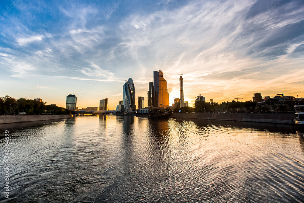 Sunset over the river with reflection of modern buildings. Moscow city above the water Sunset over the river with reflection of modern buildings. Moscow city above the water