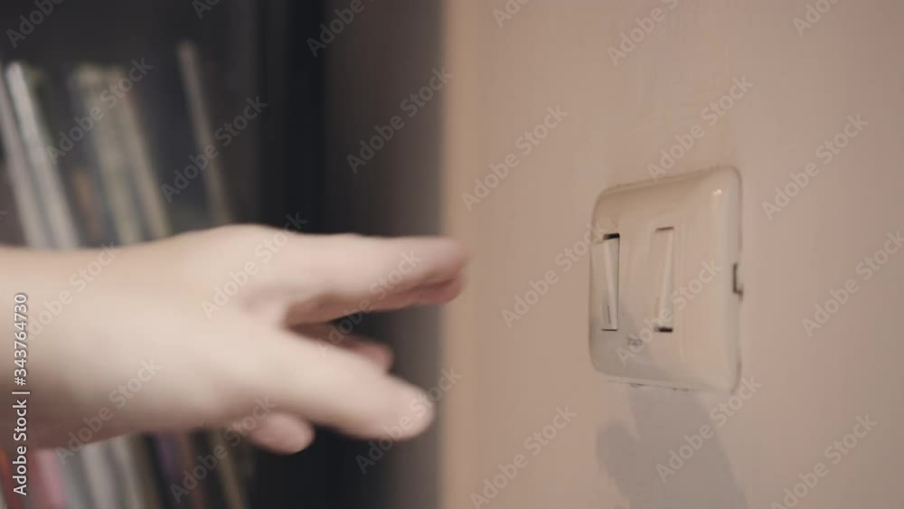4K Close up hand switch off electric light . Concept of energy and power saving.