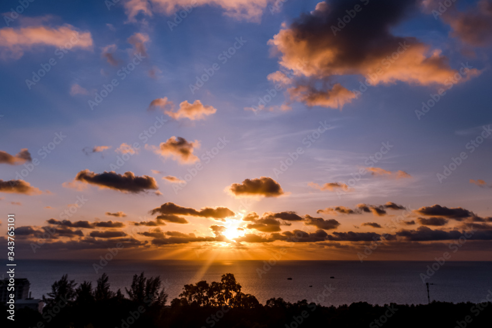 Evening sky at sunset background. Clouds hanging above horizon. Majestic cloudscape in blue, orange, violet shades Evening sky at sunset background. Clouds hanging above horizon. Majestic cloudscape in blue, orange, violet shades