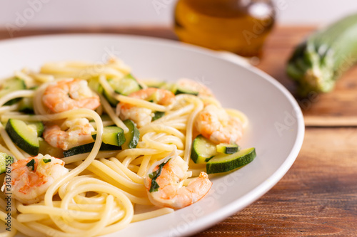 Spaghetti with shrimps and zucchini. Typical dish on italian cuisine. Summer lunch.