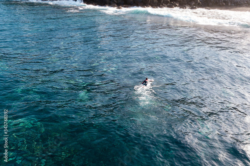 surfing in ocean aerial view