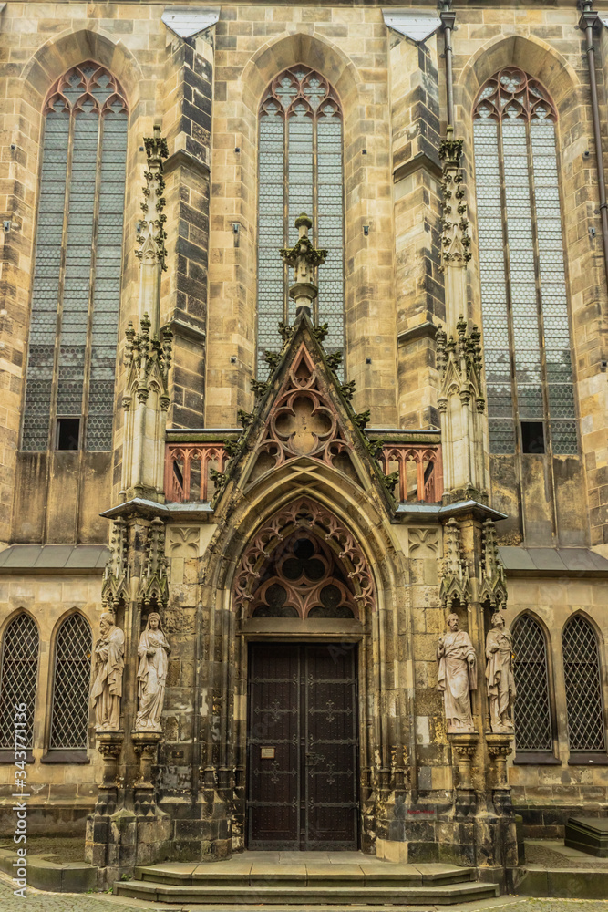 Portal of the Church of St. Thomas decorated with sculptures. Leipzig. Germany. Soft focus, blurry background.