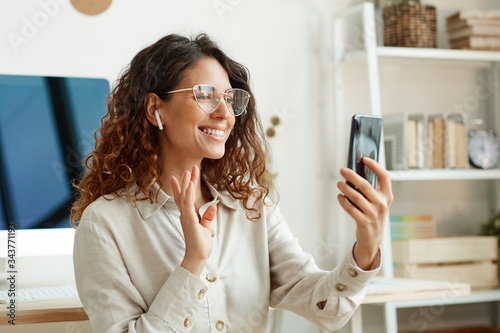 Obraz na plátně Beautiful Caucasian businesswoman wearing stylish eyeglasses having video call o
