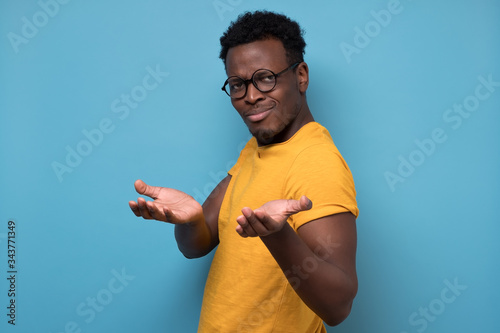 Photography African american man looking suspicious and some disgust on his face