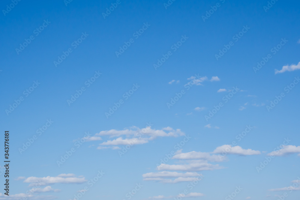 Blue sky and small white clouds .. Summer sunny day. Copy space. Pattern.