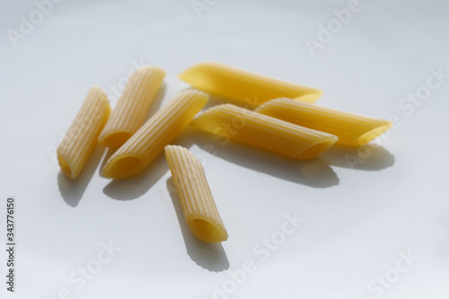 penne  crude (pasta) isolate su sfondo bianco photo