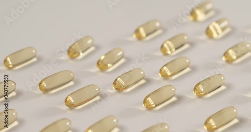 Sliding shot of healthy vitamin supplement containing cod liver oil. photo