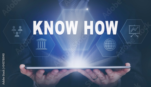 фотографія Businessman holding a computer tablet display projecting a Know How concept