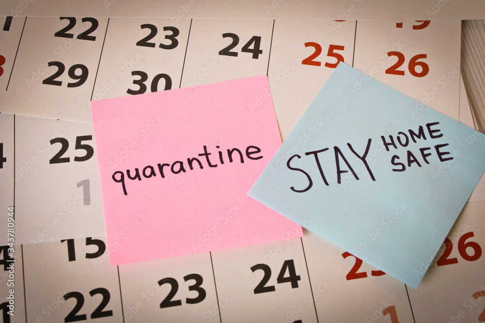 CORONAVIRUS. A sticker with the word quarantine on the calendar sheets. The concept of quarantine. Selective focus. CORONAVIRUS. A sticker with the word quarantine on the calendar sheets. The concept of quarantine. Selective focus.