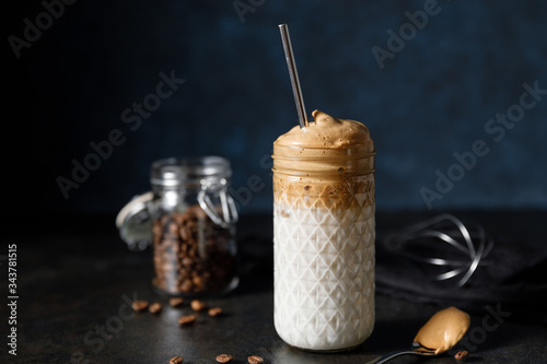 Korean coffee drink dalgona on dark wooden background photo