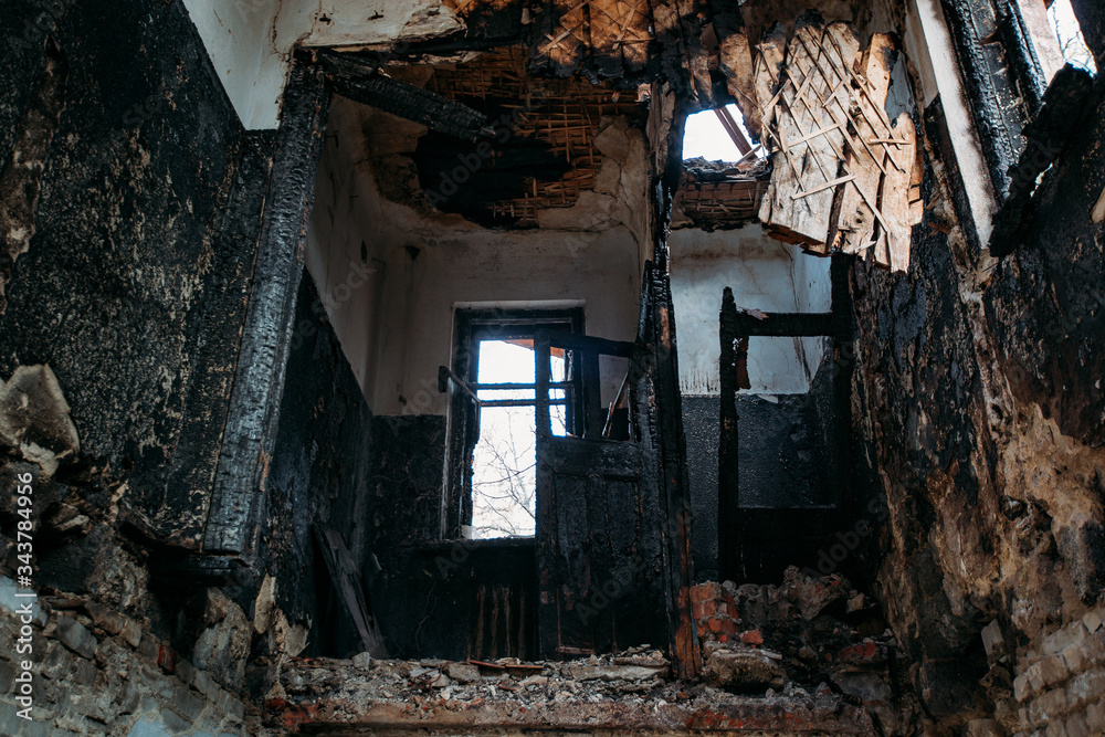 Burnt old house interior. Consequences of fire