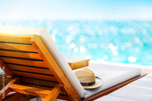 Canvas Print Lounger with sun hat and swimming pool in luxury resort
