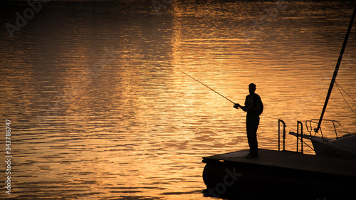 silhouette of a fisherman