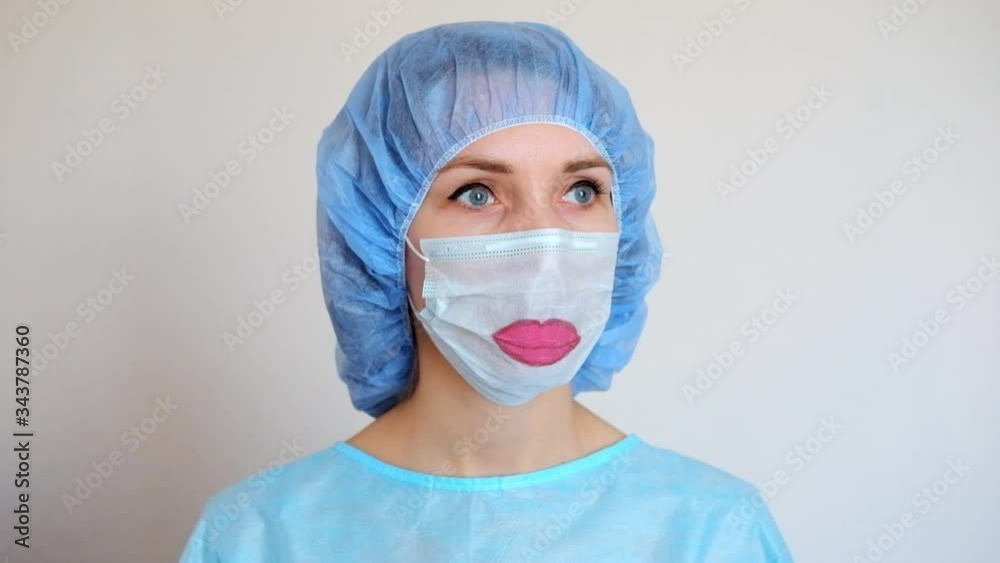 Portrait of a doctor in a mask, on which a lips is drawn. Portrait of a doctor in a mask, on which a lips is drawn.