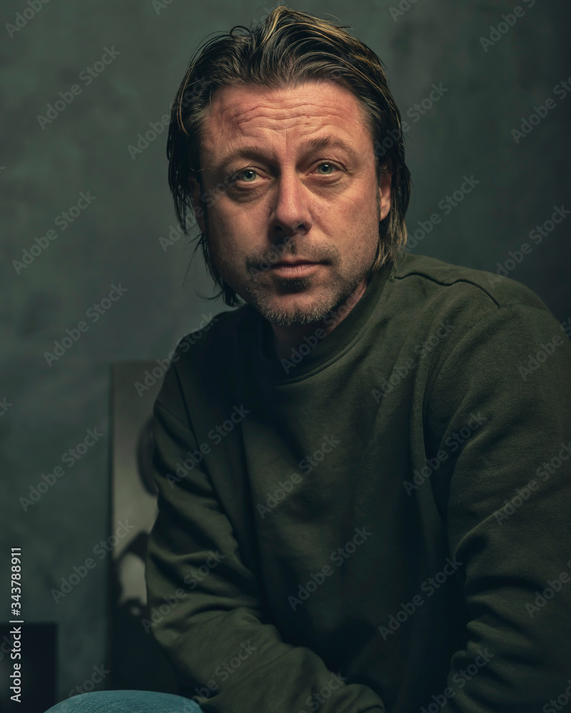 Middle aged man with stubble beard in green sweater. Middle aged man with stubble beard in green sweater.