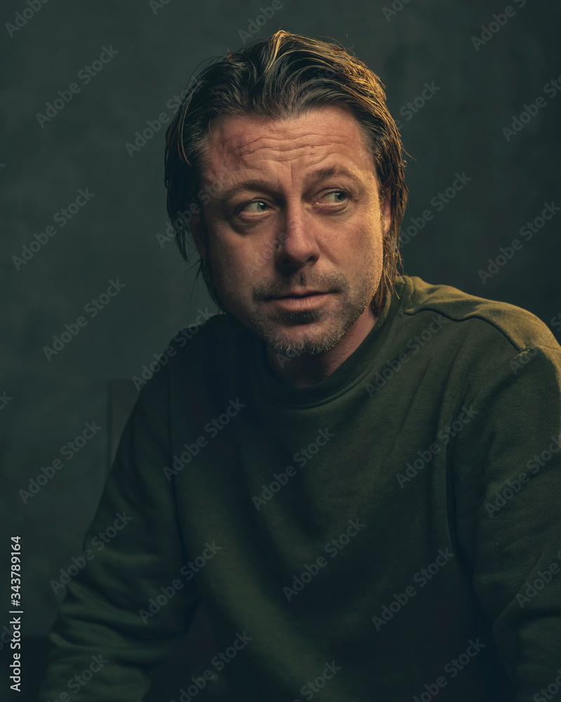 Middle aged man with stubble beard in green sweater. Middle aged man with stubble beard in green sweater.