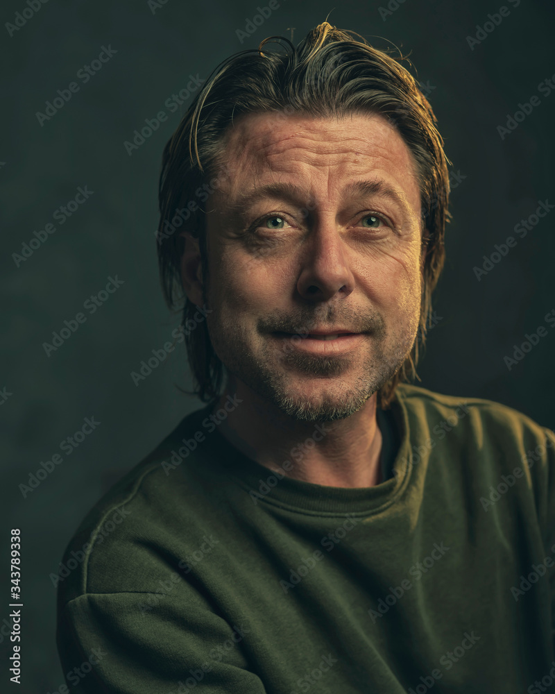 Middle aged man with stubble beard in green sweater. Middle aged man with stubble beard in green sweater.