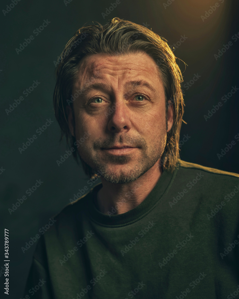 Fototapeta premium Middle aged man with stubble beard in green sweater.