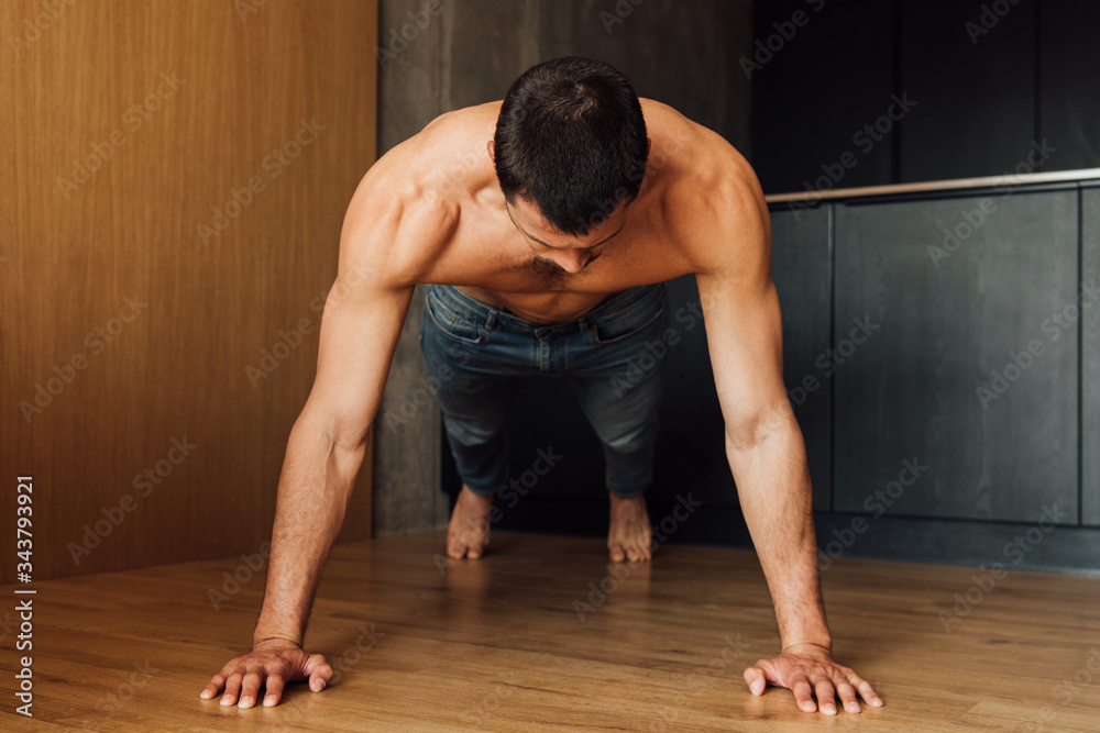 muscular man doing plank exercise at home muscular man doing plank exercise at home