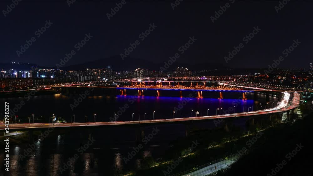Time-lapse Night view of traffic moving on the Dumogyo bridge road by the Han river in Seoul Time-lapse Night view of traffic moving on the Dumogyo bridge road by the Han river in Seoul