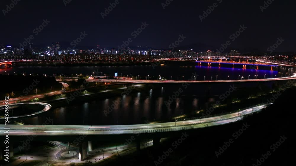 Time lapse of bridges and Cars passing in intersection, Han Riverside at Night in Downtown Seoul, South