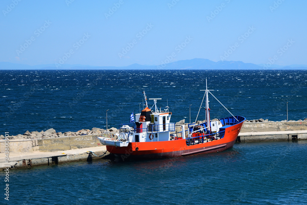 red fishing boat in Kamariotissa harbor (Samothraki) - view taken from ferry red fishing boat in Kamariotissa harbor (Samothraki) - view taken from ferry
