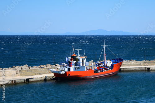 red fishing boat in Kamariotissa harbor (Samothraki) - view taken from ferry