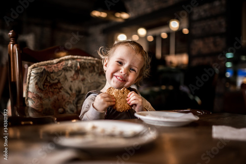 happy child eats cookies in a cafe