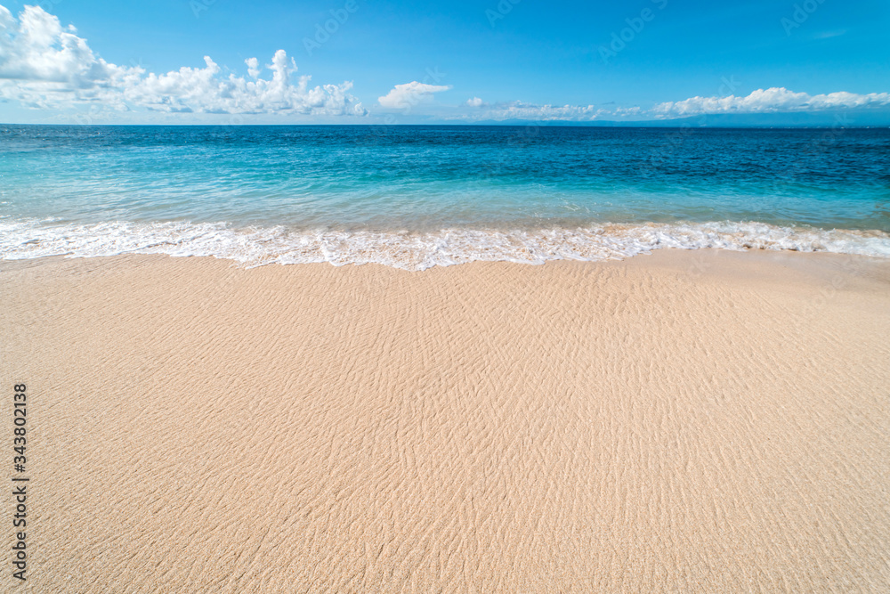 Empty Paradise sandy beach on a tropical island. Sand and sea waves. Beautiful wild beaches on the island of Bali.