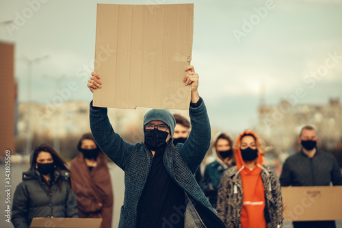 A group of people with mask and posters to protest The protest of the population against coronavirus and against the introduction of quarantine Meeting about coronavirus and people rights. copyspace photo