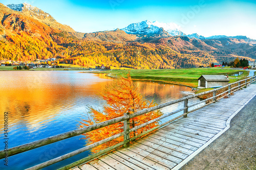 Awesome autumn panorama of Silvaplana lake and Surlej village. photo
