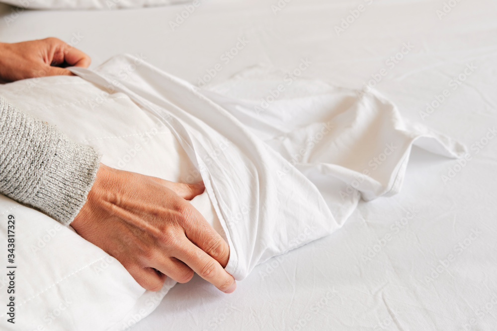 caucasian man making the bed caucasian man making the bed