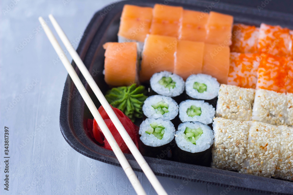 sushi delivery, home delivery in plastic and paper packaging, contactless delivery during the coronavirus epidemic